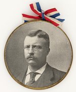 OVERSIZED THEODORE ROOSEVELT BRASS FRAME PAPER PORTRAIT BADGE.