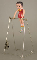 "BETTY'S ACROBAT" BETTY BOOP CELLULOID WIND-UP TRAPEZE TOY.