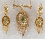 18K YELLOW GOLD VICTORIAN PERIDOT AND DIAMOND NECKLACE AND EARRING SET WITH FRINGE.