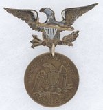 GREELEY & BROWN 1872 TOKEN SUSPENDED FROM BRASS SHELL EAGLE.