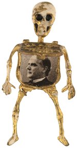 CLASSIC "DEATH TO TRUSTS" MCKINLEY MECHANICAL SKELETON BADGE.