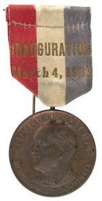 1933 "LUCKY TILLICUM: REBUILD WITH ROOSEVELT" INAUGURATION BADGE.