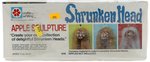 SHRUNKEN HEAD APPLE SCULPTURE SET FACTORY SEALED IN BOX.