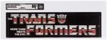 TRANSFORMERS (1985) - SMALL AISLE HANGER SIGN (TRANSFORMERS LOGO) AFA 80+ NM.