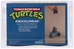 TEENAGE MUTANT NINJA TURTLES (1988) - KNUCKLEHEAD SERIES 1 VEHICLE AFA 80+ NM.