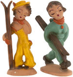 PIN-UP SKIERS STATUE PAIR.