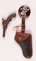 "TIM McCOY" BUTTON W/MINIATURE HOLSTER AND SINGLE SHOT CAST IRON CAP PISTOL.