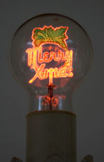 "MERRY XMAS" LIGHT BULB IN GLASS HOLDER.