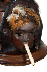 FLAPPER FIGURAL CIGARETTE DISPENSER.