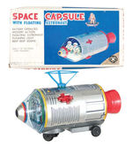 "BATTERY OPERATED SPACE CAPSULE WITH FLOATING ASTRONAUT."