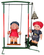 BOY AND GIRL AT SWING CELLULOID WIND-UP WITH BOX.