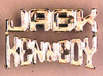 JFK DIECUT WHITE METAL PIN W/BRILLIANT GOLD LUSTER.