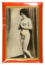 CELLULOID-COVERED PLAQUES FEATURING PHOTOS OF NUDE FEMALE MODELS.