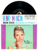 AUDREY HEPBURN SIGNED "MOON RIVER AND BREAKFAST AT TIFFANY'S" 45RPM RECORD.