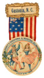 UNCLE SAM DANCING WITH MISS LIBERTY RIBBON BADGE FOR 1902 GASTONIA, NORTH CAROLINA EVENT.