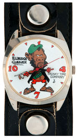 "ELDRIDGE CLEAVER" HOLDING MACHINE GUN AND GIVING "BIRD" C. 1968 WATCH BY DIRTY TIME CO.