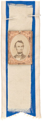 LINCOLN 1864 CARDBOARD PHOTO BADGE ON PAIR OF ORIGINAL RIBBONS.