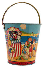 CHILDREN AT THE BEACH SAND PAIL.