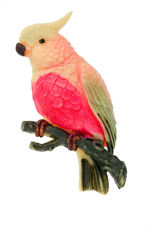 PARROT ON TREE BRANCH HIGH RELIEF CELLULOID PIN FROM 1930s.