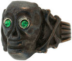 CROSS BONES AND HIGH RELIEF SKULL WITH PIERCING GREEN RHINESTONE EYES RING.