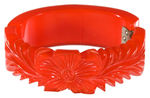 ORANGE BAKELITE FLOWER AND LEAF DESIGN DEEPLY CARVED HINGED BRACELET CIRCA 1940.