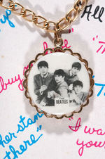 “THE BEATLES” ROUND PORTRAIT VARIETY PAIR OF CARDED BRACELETS.