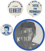 FOUR JOHN F. KENNEDY BUTTONS INCLUDING A FLASHER, LITHO AND TWO SLOGAN BUTTONS.