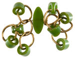 GREEN BAKELITE PIN HOLDING EIGHT TWISTED BRASS RINGS WITH EIGHT BEVEL CUT BAKELITE ACCENTS.