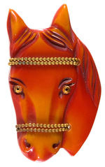 CARVED BAKELITE HORSE HEAD PIN WITH ACCENTS OF GLASS EYES AND BEADED BRASS BANDS.