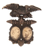 HANCOCK/ENGLISH CARDBOARD JUGATE PHOTOS ON BRASS SHELL BADGE.