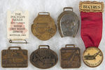 CONSTRUCTION EQUIPMENT GROUP OF FIVE WATCH FOBS AND TWO BADGES.