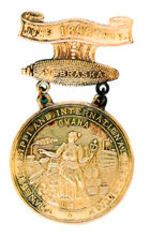 "NEBRASKA" TRANS-MISS. BRASS BADGE.