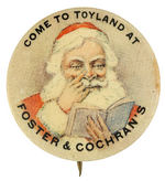 SANTA BUTTON C. 1915 WITH FINGER NEXT TO NOSE AS HE STUDIES HIS OPEN BOOK.