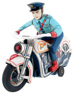 BATTERY OPERATED POLICEMAN ON MOTORCYCLE.