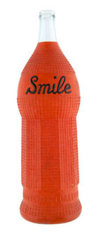 "SMILE" ORANGE SODA GLASS ADVERTISING DISPLAY BOTTLE.