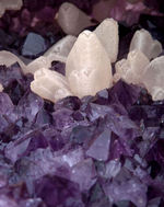 LARGE AMETHYST GEODE WITH DOGTOOTH CALCITE CRYSTALS.