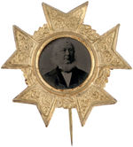 HORACE GREELEY 1872 FERROTYPE IN FANCY EMBOSSED SHELL FRAME WITH STICKPIN.