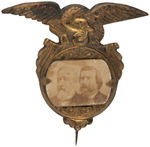 BLAINE AND LOGAN 1884 JUGATE CARDBOARD PHOTO ON LARGE EMBOSSED BRASS SHELL STICKPIN.