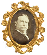 TAFT UNLISTED REAL PHOTO OVAL IN ORNATE BRASS SHELL FRAME.