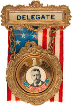 “DELEGATE” RIBBON BADGE WITH ENCASED THEODORE ROOSEVELT BUTTON.