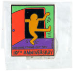 KEITH HARING PIN-BACK AND TWO ENAMEL PINS FROM 1988-1998.