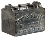 WESTINGHOUSE BATTERY/TRYON’S GARAGE FIGURAL PAPERWEIGHT.