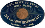 CONN MUSICAL INSTRUMENTS MIRROR WITH ENCASED INDIAN HEAD PENNY.