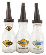 “SUNOCO” LOT OF SEVEN OIL BOTTLES WITH CARRIER.