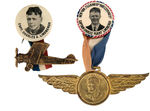 LINDBERGH BUTTON PAIR WITH EMBOSSED BRASS SUSPENSIONS.