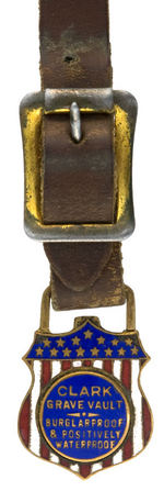 "CLARK GRAVE VAULT/BURGLAR PROOF AND POSITIVELY WATER PROOF" ENAMEL ON BRASS WATCH FOB.