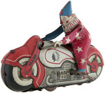 ACROBATIC CLOWN ON MOTORCYCLE WIND-UP.