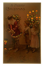 HOLD TO LIGHT SANTA CLAUS POSTCARD WITH BOY, GIRL & TREE.