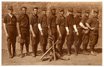 1909 BASEBALL TEAM REAL PHOTO POSTCARD WITH BLACK PLAYER IN CENTER OF WHITE PLAYERS.