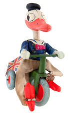 DONALD DUCK ON TRICYCLE WIND-UP WITH BRITISH UNION JACK FLAG.